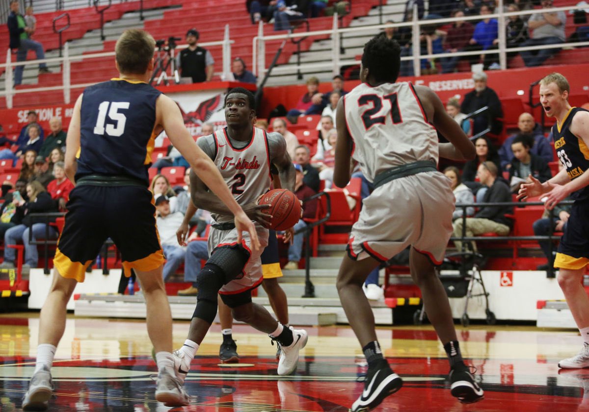 Ayo driving to the basket at Casper College, USA